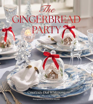 A festive holiday table setting with multiple place settings, glass cloches holding gingerbread houses tied with red ribbons, and the title text 'The Gingerbread Party' overlaid at the top.
