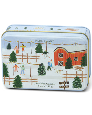 Paddywax tin candle with a winter scene design on a white background. Tobac & Pine.
