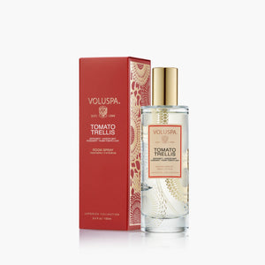 Voluspa Tomato Trellis room spray bottle with a gold cap next to its red packaging box, set against a clean white background.