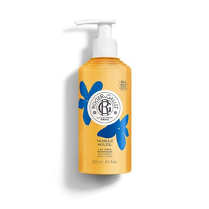 Yellow body lotion bottle from Roger & Gallet with blue floral design on a white background. Vanille Soleil. 