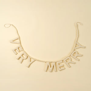 Holiday felt garland with 'Very Merry' letters on a beige background