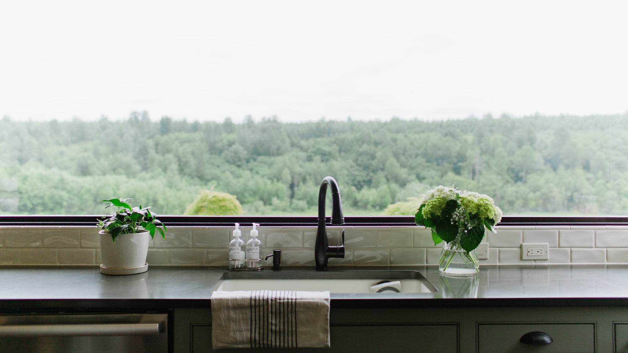 Kitchen window with hydrangeas and dish towel, design 