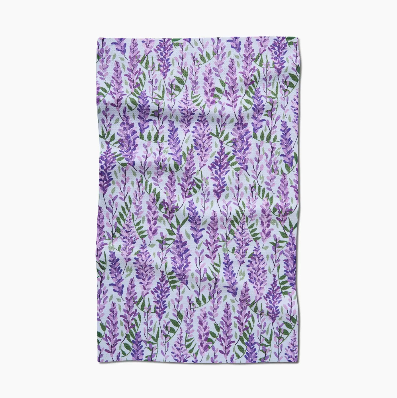 Floral patterned tea towel with purple wisteria flowers and green leaves against white background. 