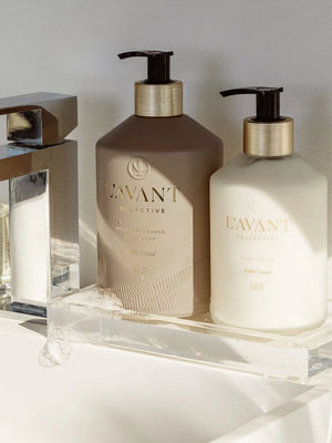 NEW LAVANT Ambre Santal hand lotion and hand soap on a clear stand.