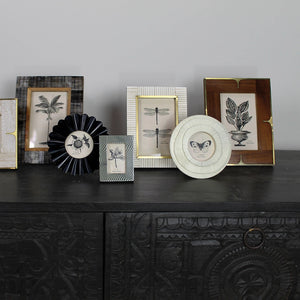 Collection of decorative frames on a dark surface with a gray background