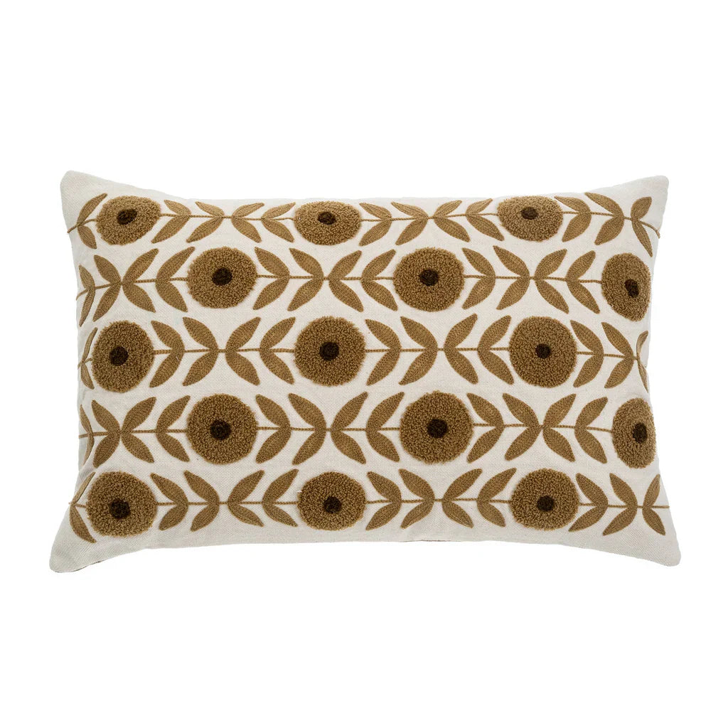 Decorative lumbar linen pillow with embroidered brown floral pattern on a white background. 