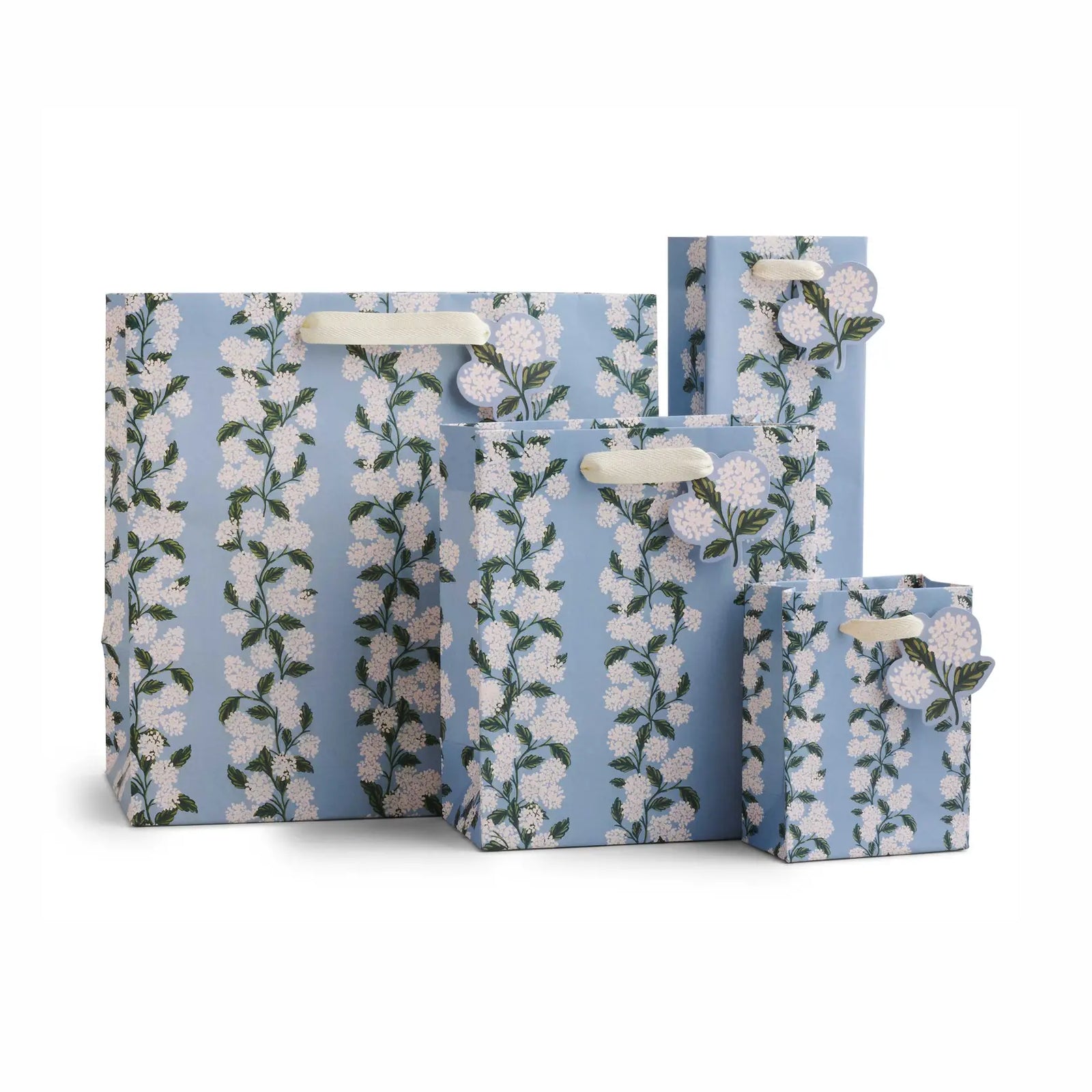 Set of four light blue hydrangea floral-patterned gift bags on a white background.