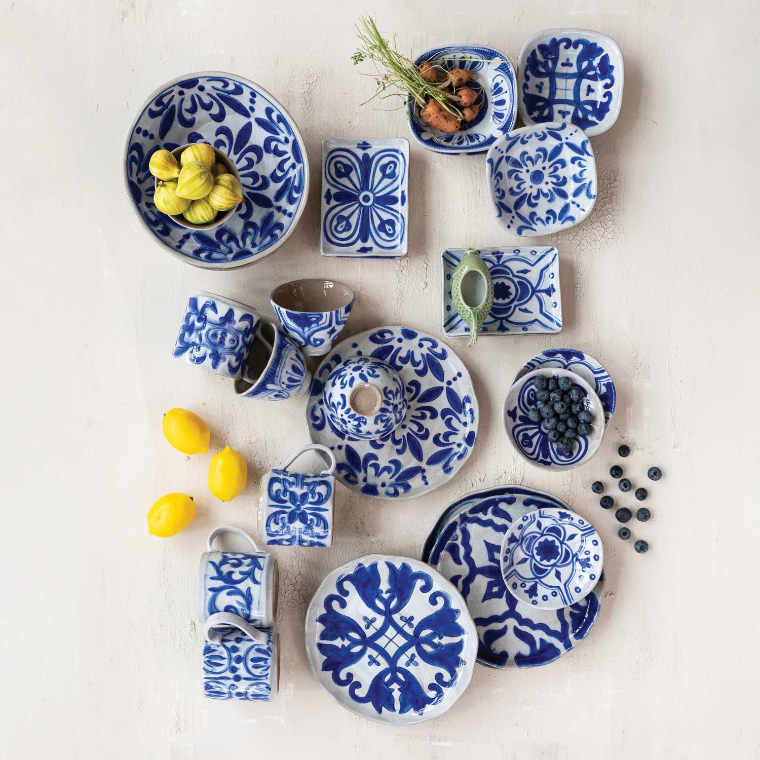 various plates, bowls, and dishes in hand painted blue and white designs. 