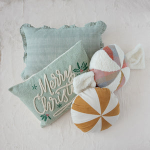 Decorative pillows with 'Merry Christmas' text and candy cane design on a light background