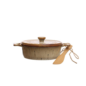 Ceramic brie maker with lid and wooden handle on a white background