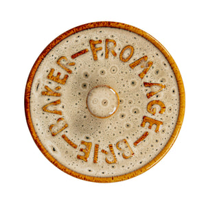 Round brie maker lid with 'Baker Fromage Brie' text on a white background.