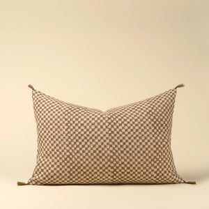 Decorative linen lumbar pillow with a check block pattern on a beige background. 