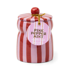 A pink and red striped ceramic jar candle with a matching lid and a round hanging tag that reads 'Pink Pepper Mint' on a white background.