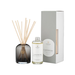 Cashmere Diffuser set with bottle, sticks, and packaging on a white background