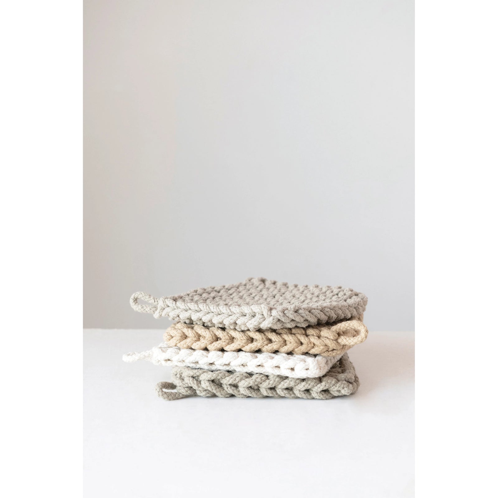 collection of neutral colored cotton pot holders. 