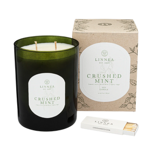 Linnea Crushed Mint candle with packaging and matches on a white background