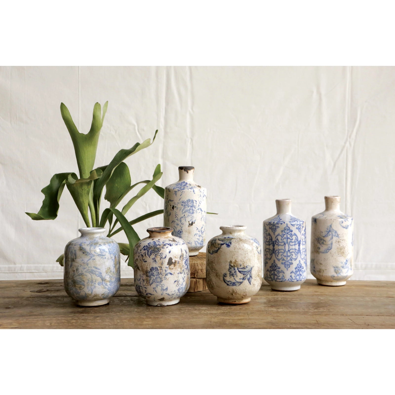 Collection of antique blue and white farmhouse decorative vases in varying sizes. 