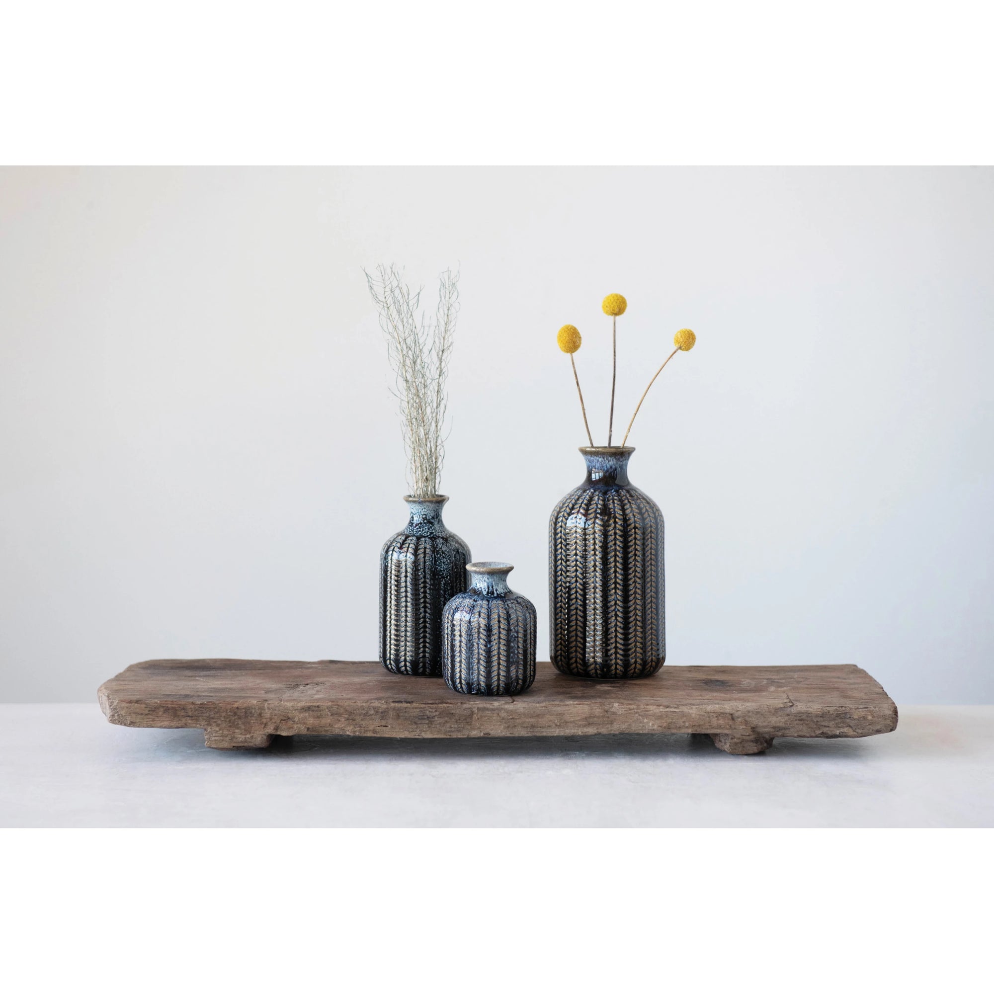 Small, Medium, and Large embossed glazed stoneware vases in deep blue color