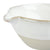 Magnified view of pouring spout on white and natural ceramic batter bowl. 