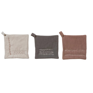 Linen, grey, and washed terracotta embroidered slub cotton pot holders. 