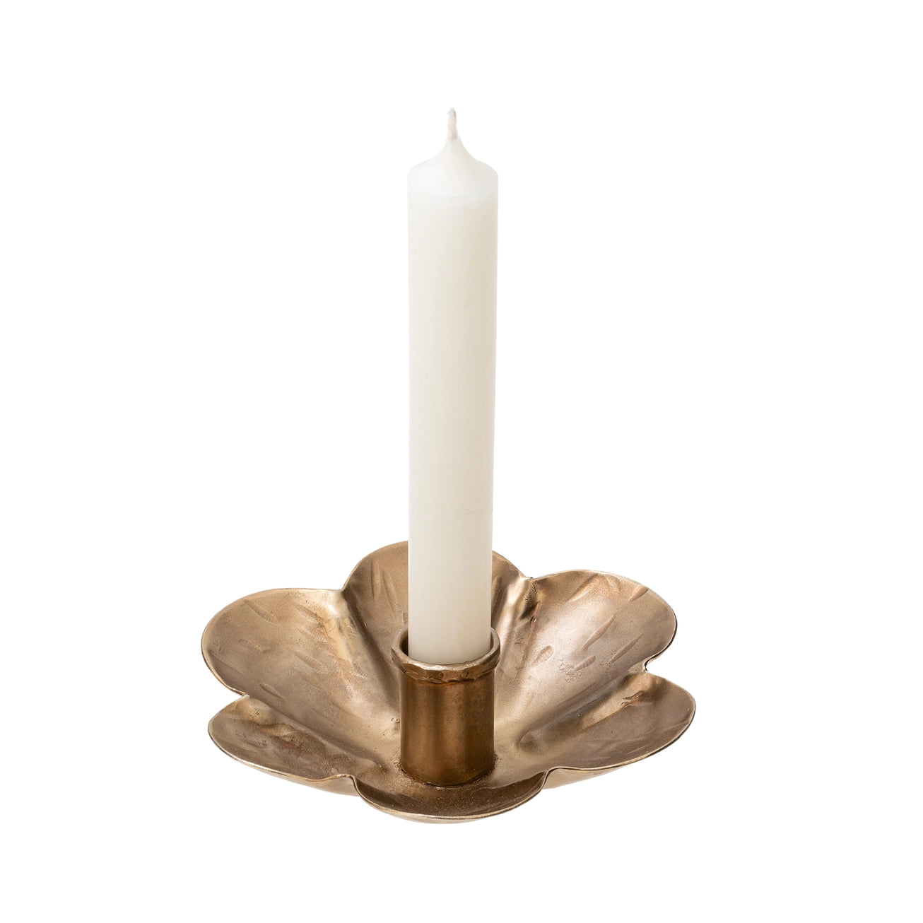 Brass flower candle holder with a white candle on a white background