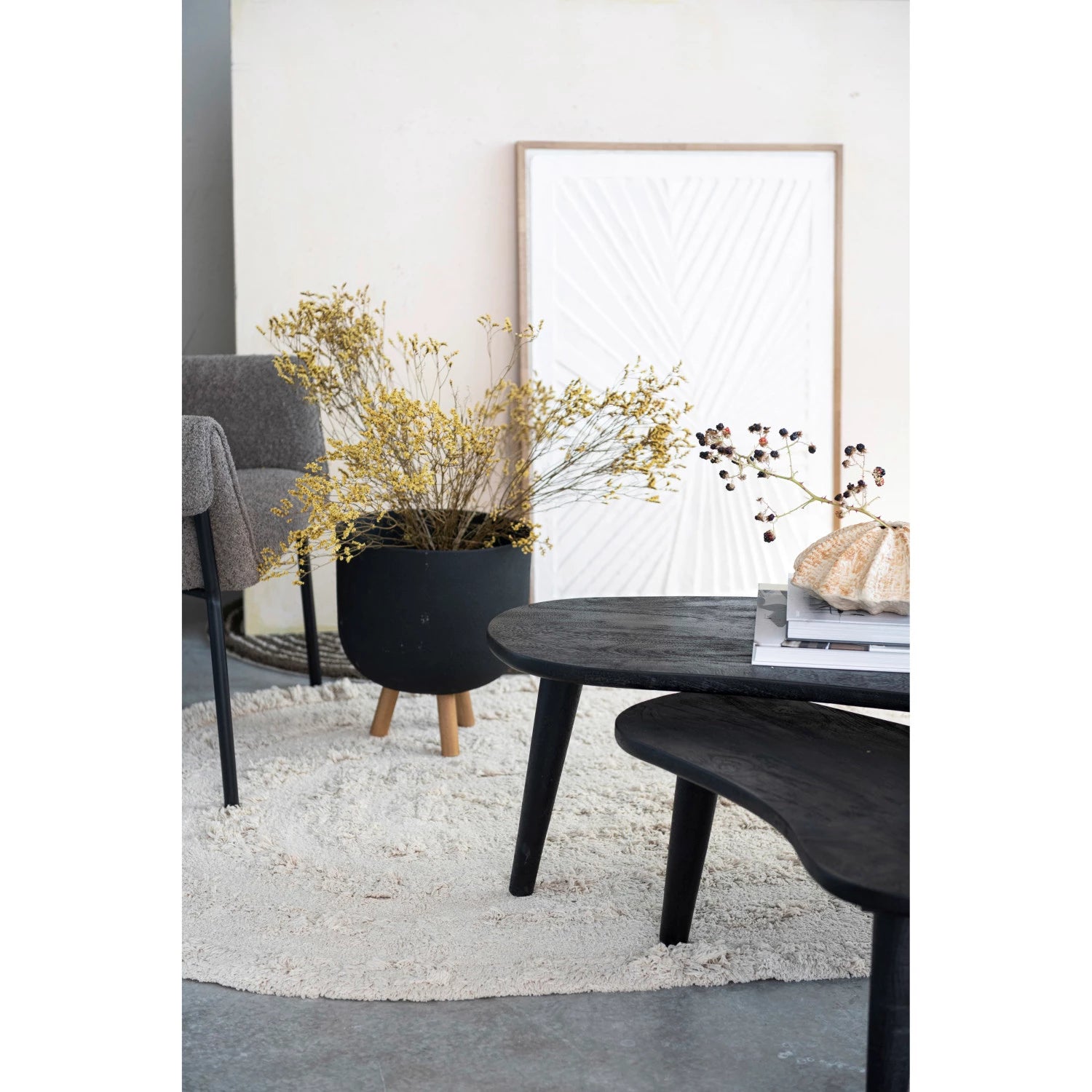 Textured paper mache art in the background of a styled home.