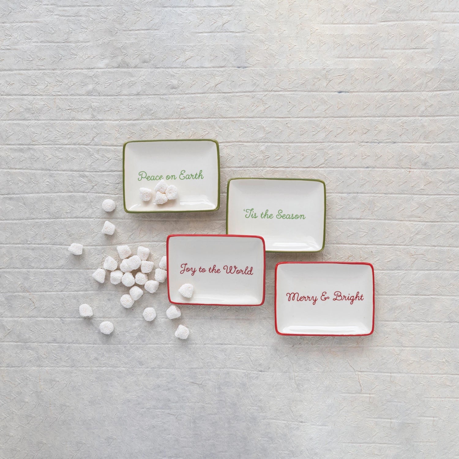 holiday stoneware collection in cream, red, and green. Comes in four different sentiments