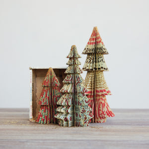 Set of decorative paper Christmas trees with a retro patterned design on a neutral background.