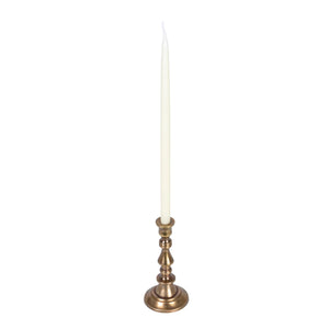 Mini antique brass candle votive holder with a white candle on a white background.