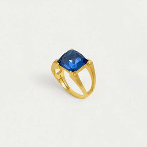 Gold ring with a midnight blue gemstone on a light gray background. Dean Davidson jewelry