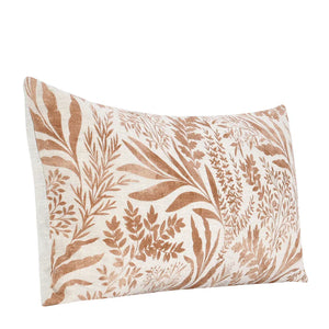 Linen lumbar pillow with terracotta orange floral pattern in a watercolor style.
