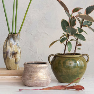 collection of artisan ceramics and vases with plants inside on stone table. 