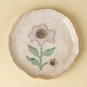 Ceramic dinner plate with floral Aster bloom design on a beige background.  Scalloped edge detail. 