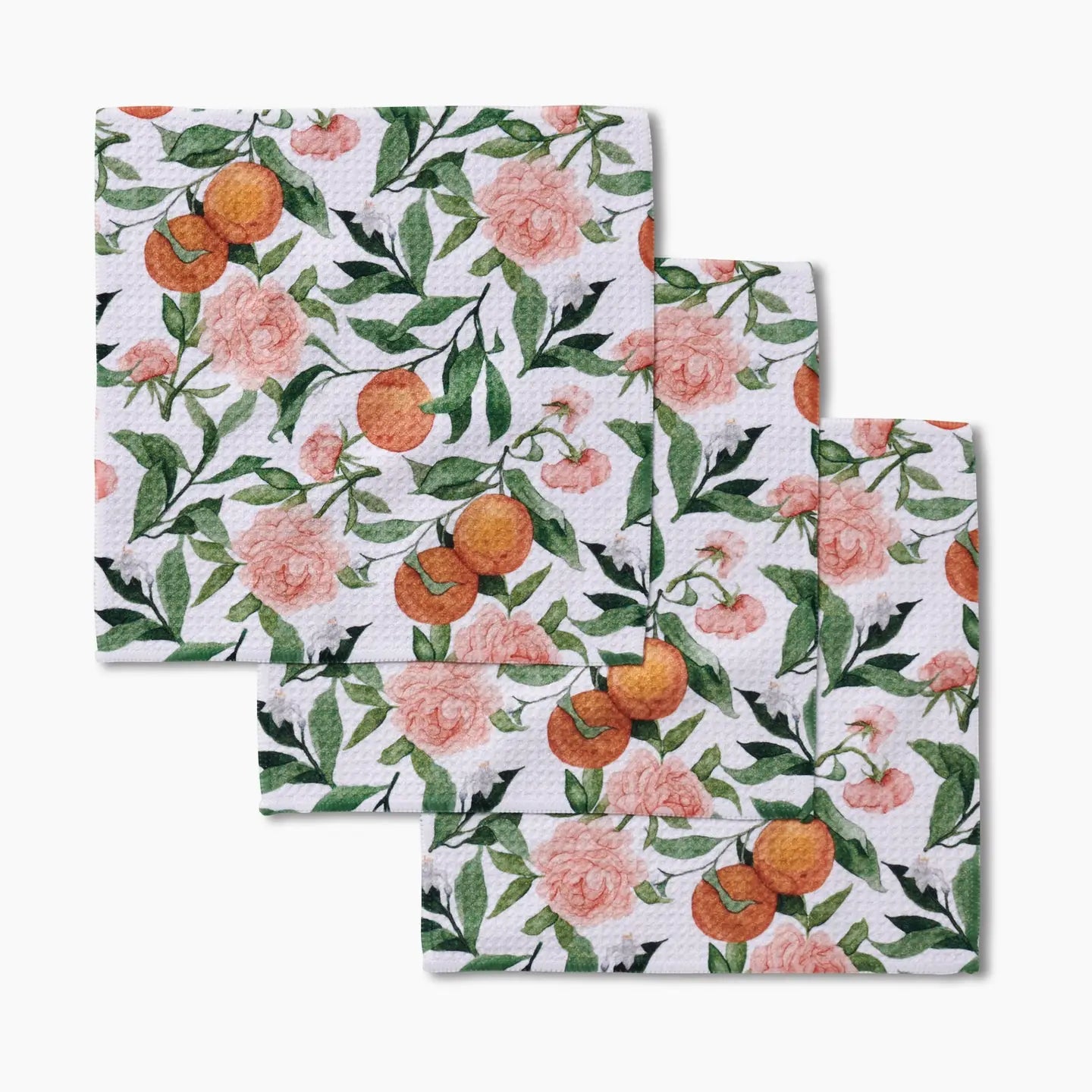 Set of three dishcloths with floral and fruit pattern on a white background