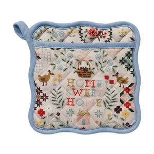 Quilted pot holder with 'Home Sweet Home' text, floral, and farm animal patterns on a white background. 