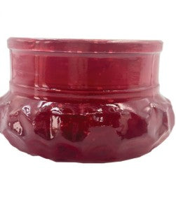 A small glossy red ceramic bowl with a textured, embossed floral pattern on the lower half, shown against a plain white background.