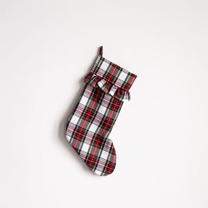A single Christmas stocking with a red, white, and black plaid pattern, featuring a ruffled cuff and a hanging loop, shown against a plain white background.