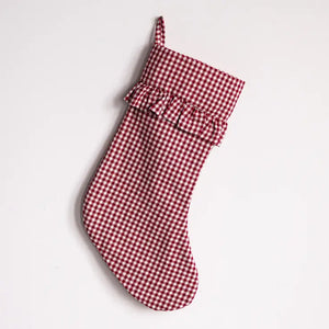 A red and white gingham Christmas stocking with a ruffled trim, shown against a plain white background.