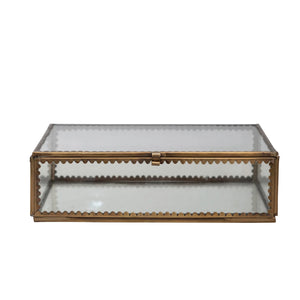 Decorative glass box with gold metal scalloped edge frame on a white background. 