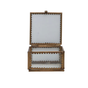 Open scalloped edge brass trinket box with glass sides on a white background.