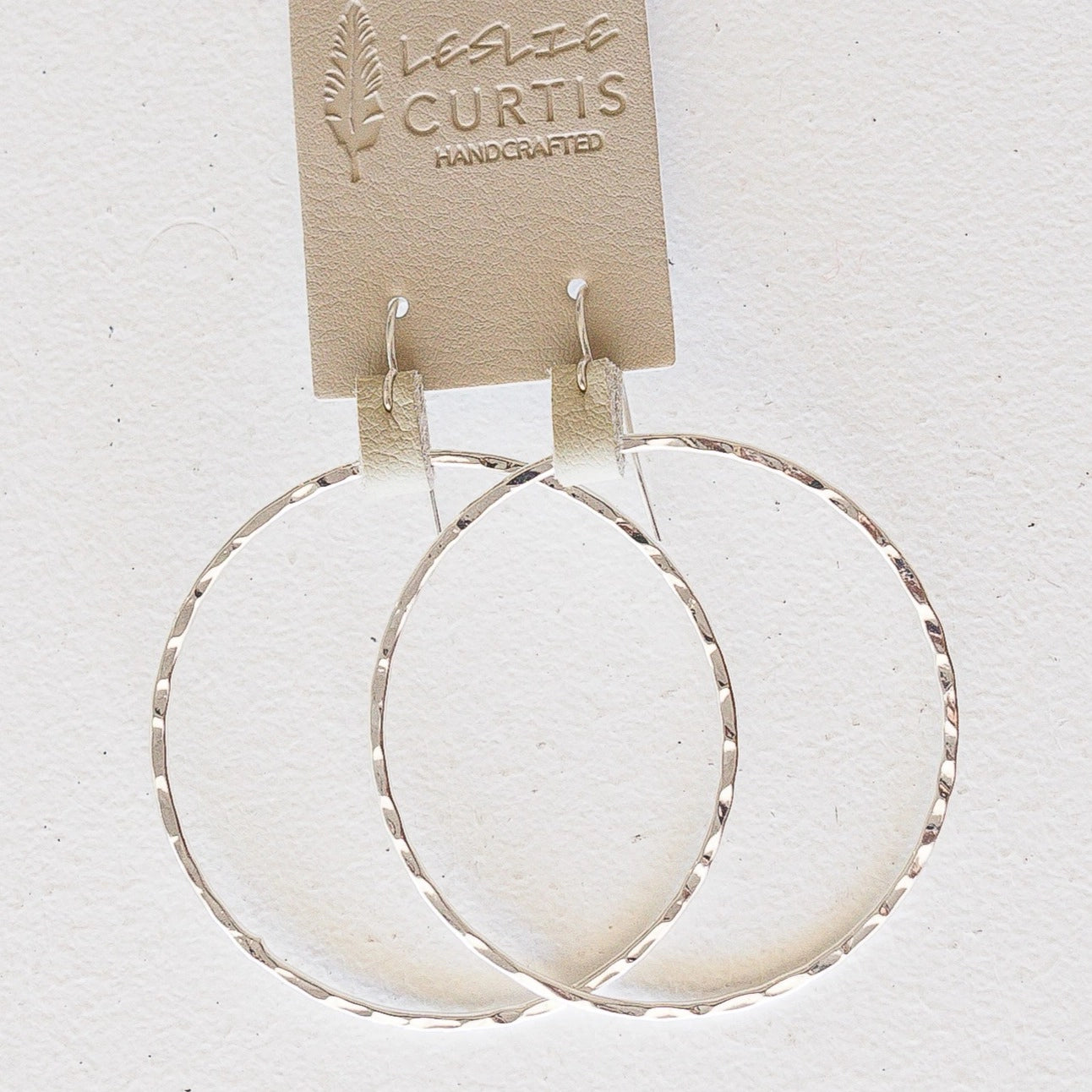 Minimalist Silver hoop earrings with sand colored leather detail. Leslie Curtis handcrafted in USA. 