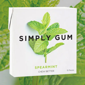 Box of Spearmint Simply Gum with green leaves on a green background