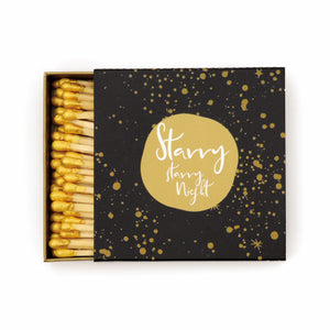 black match box with gold speckles and gold circle with saying "starry starry night"