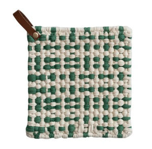 A square woven potholder with a green and off-white basketweave pattern and a brown leather loop handle, shown on a plain white background.