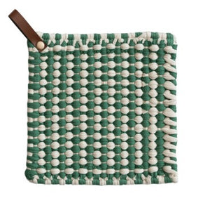 A square woven potholder with a green and off-white basketweave pattern and a brown leather pull tab on a white background.