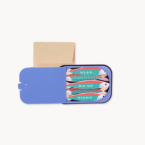 Pop up card of small sardine tin with multiple fish illustration and 'Glad We're Tight' text. 