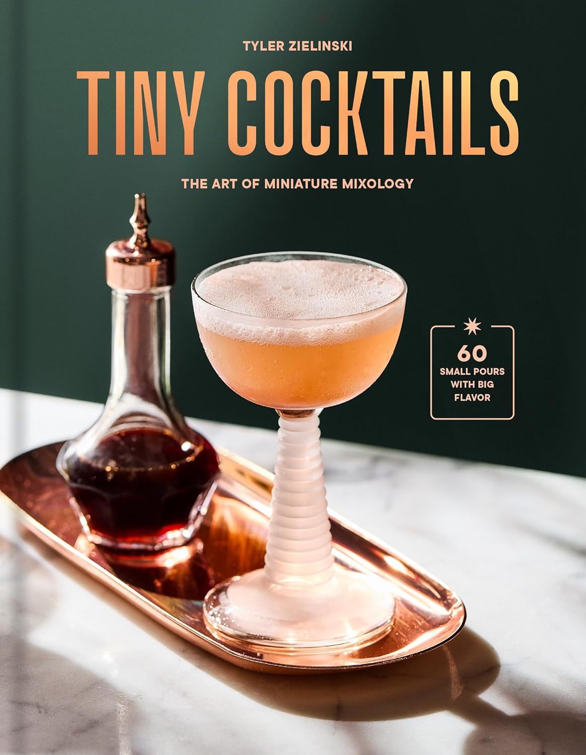 Photographed miniature cocktail with bitters bottle displayed on copper tray. Front cover art for bar book "Tiny Cocktails" written by Tyler Zielinski. 