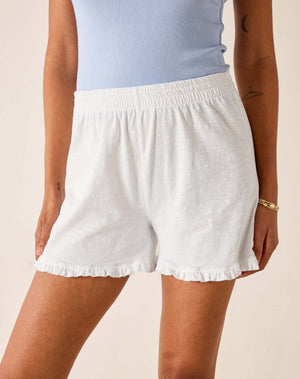 White cotton tee ruffled shorts with elastic waistband. 