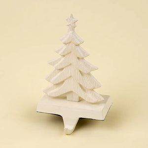 White Christmas tree stocking hanger displayed against a beige background. 