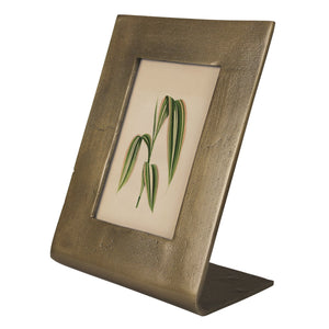 Bronze picture frame with a small painting of leaves on a white background